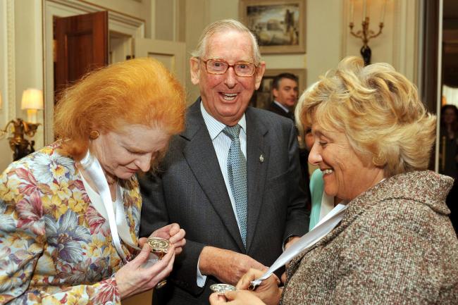 Lord Sainsbury laughs as Dr Carol Hogel CBE (left) and Dame Vivien Duffield CBE, study their Prince of Wales Medals for Arts Philanthropy at Clarence House in central London.