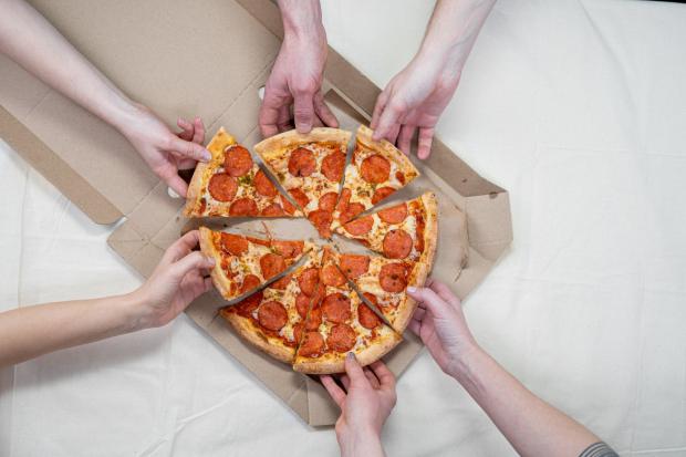 Falmouth Packet: People sharing a Pepperoni pizza. Credit: Canva