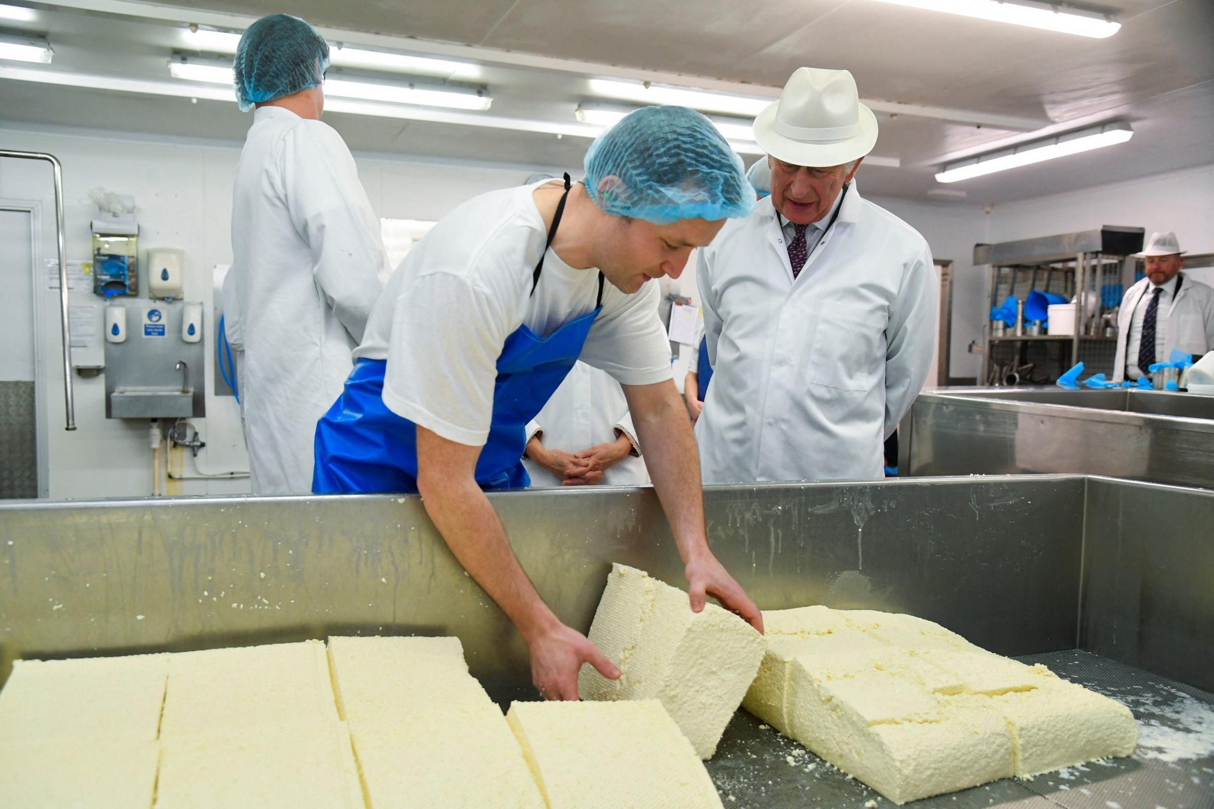 The Prince watches as cheese maker Tom Monk turns and drains Yarg cheese Picture: PA Wire