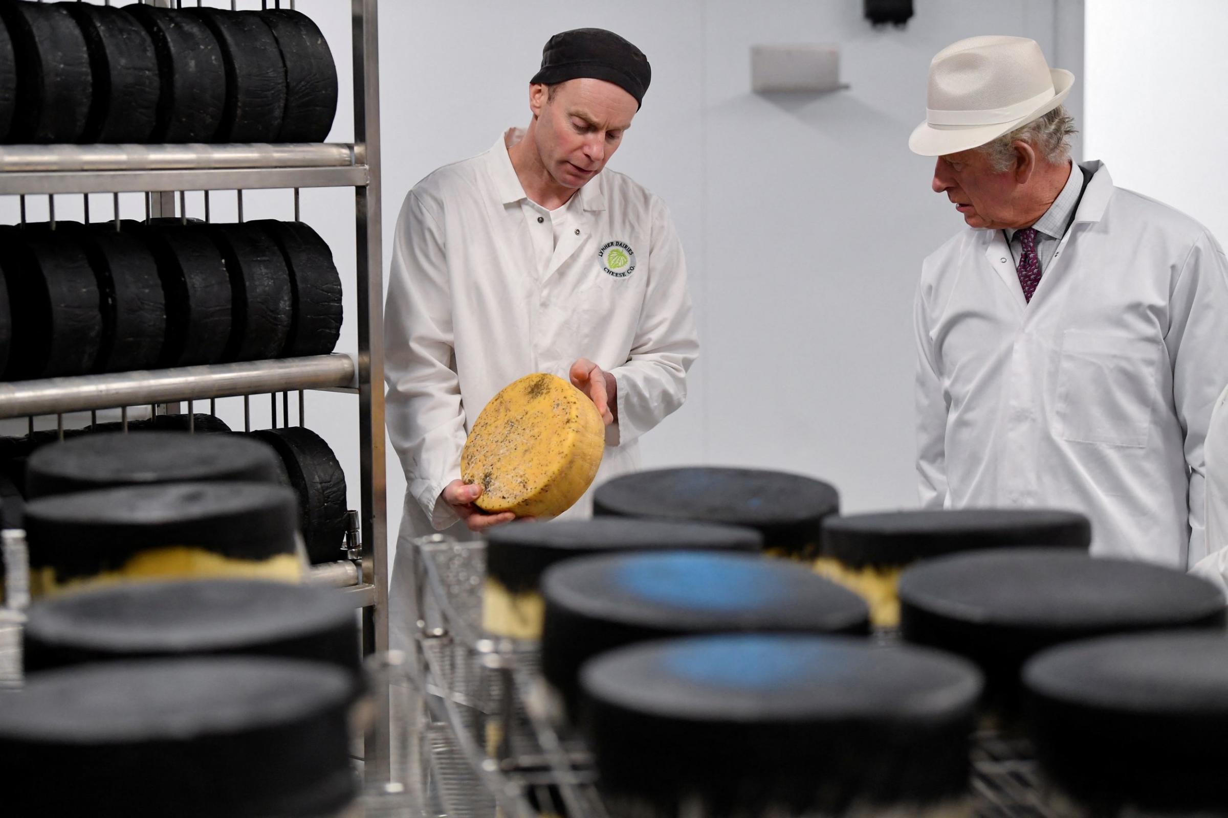Cheese maker Leighton Moyles shows the Prince of Wales a sample of Kern cheese in the resting room Picture: PA Wire