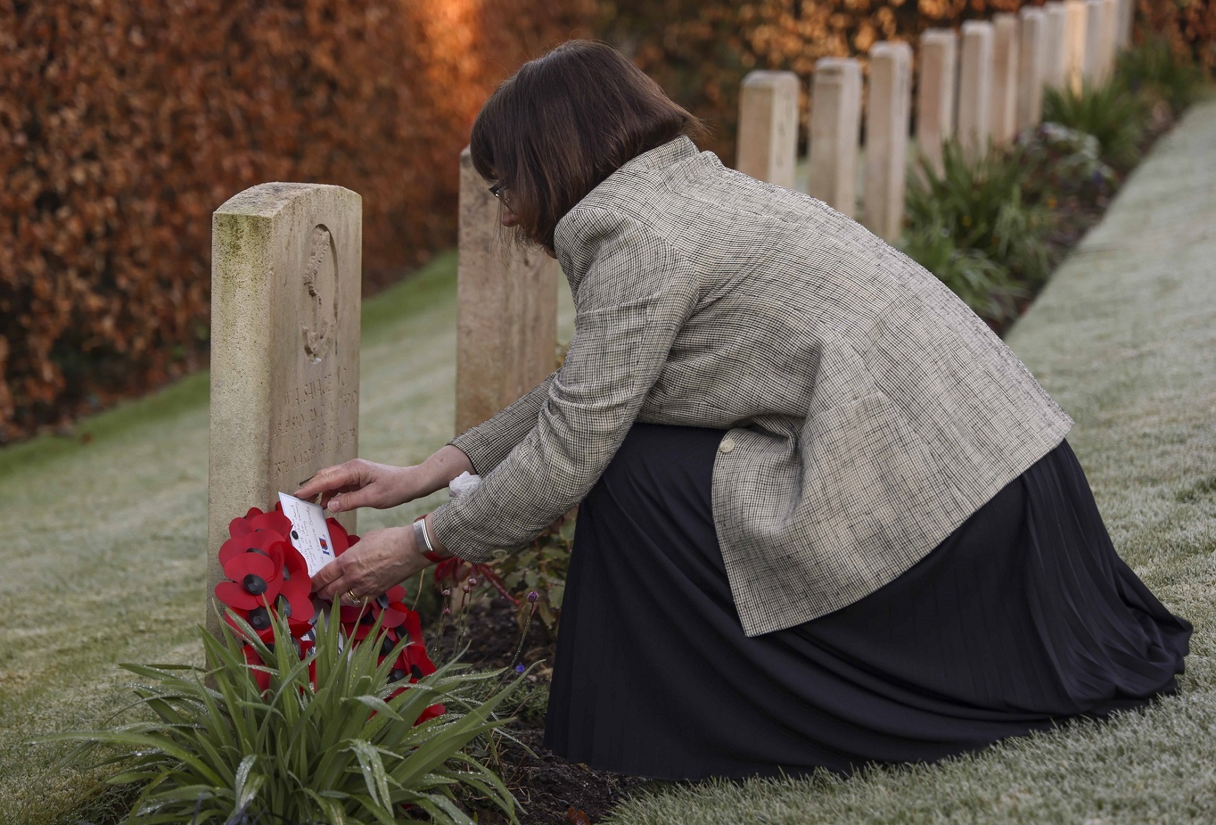 Caroline Carr (great niece) places a wreath at the headstone of Able Seaman Bill Savage VC during a small memorial service held at Falmouth Cemetery. Credit: LPhot Dan Rosenbaum, RNAS Yeovilton