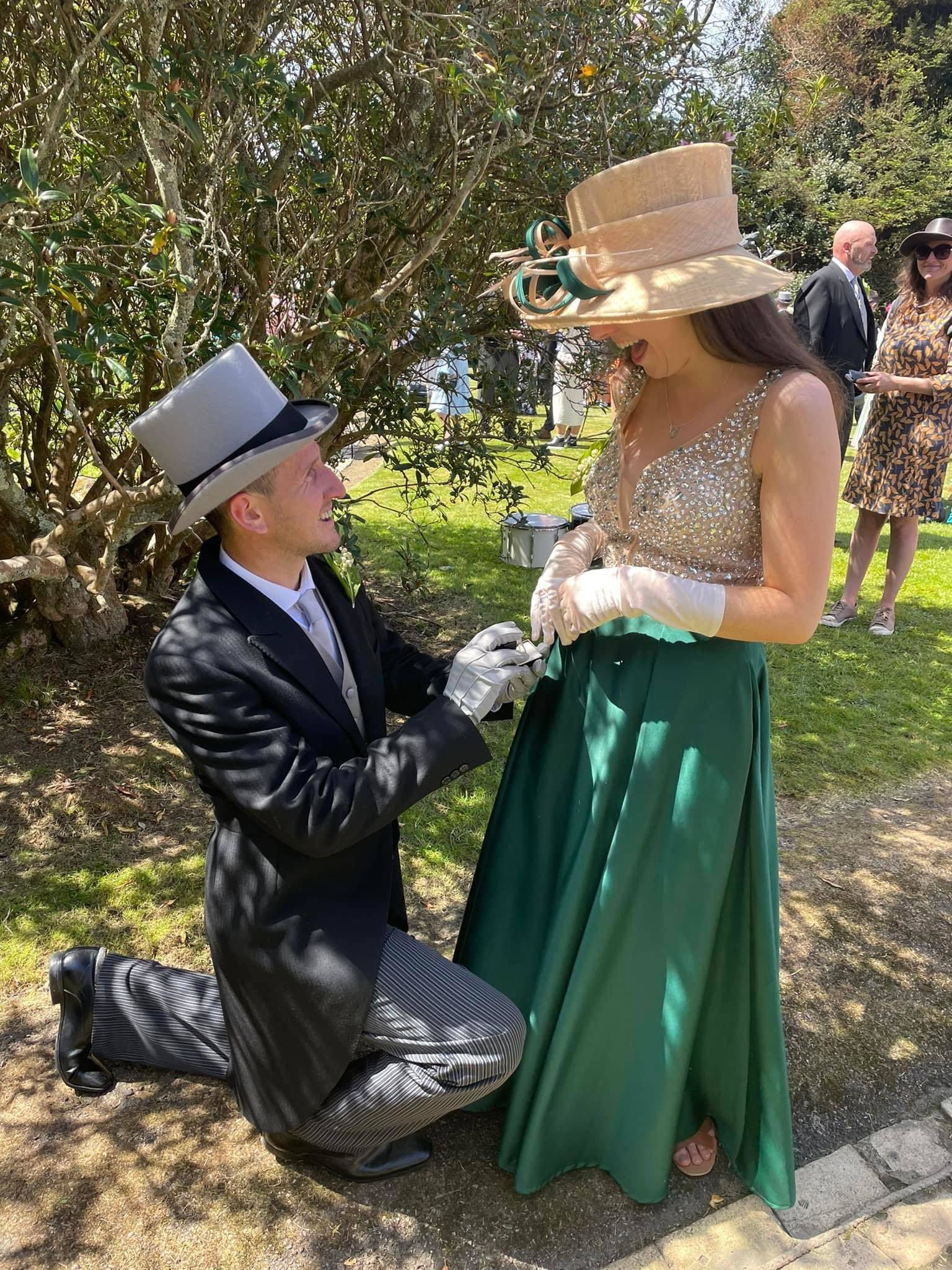 Bobby drops down to one knee to propose to Amy in Lismore Gardens. 