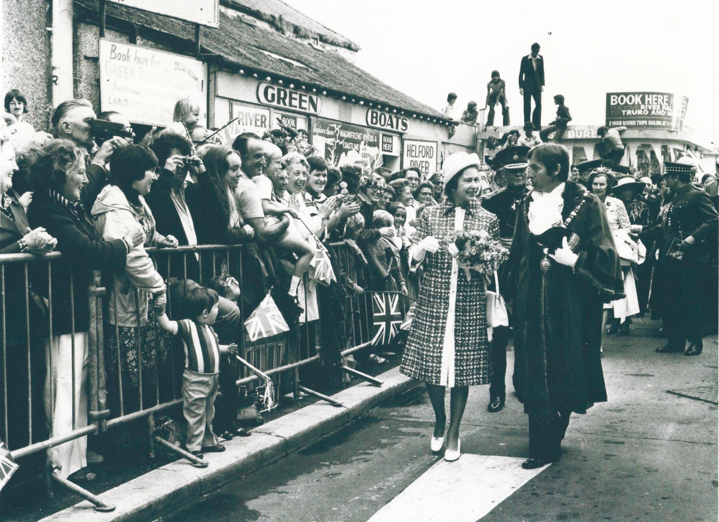 The Queen is welcomed along the Princes of Wales Pier in Falmouth by mayor Geoffrey Evans in 1977