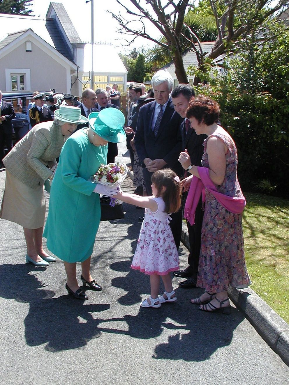 The Queen receiving flowers from three-year-old Olivia Tapenden and her mother Amanda, assistant manager of Blackwood Care Home in Camborne, in 2006