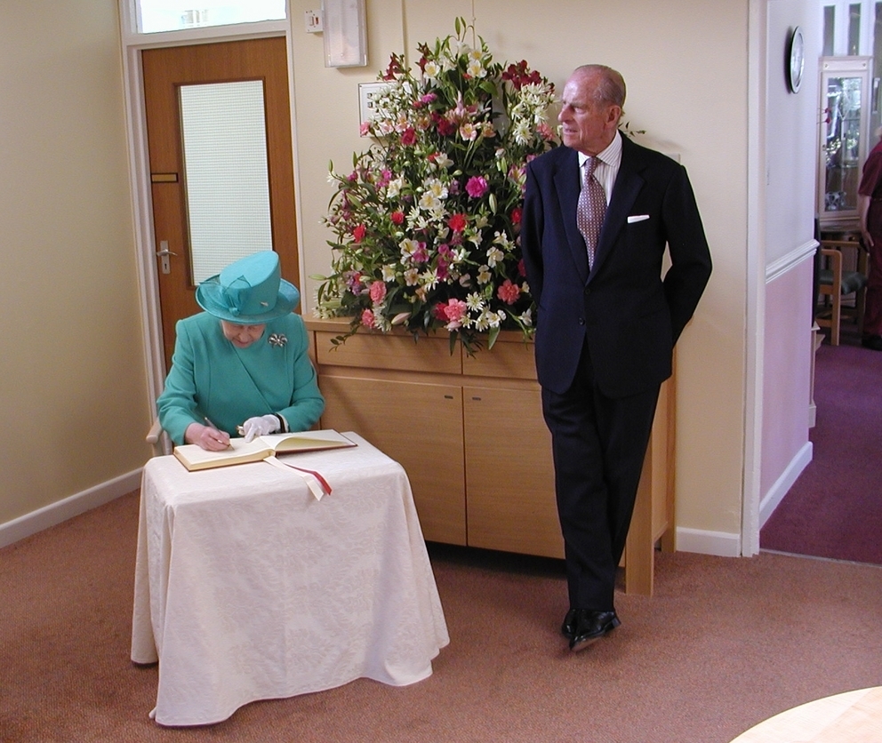 The Queen signs the visitors book at Mountford House with Prince Philip in 2006