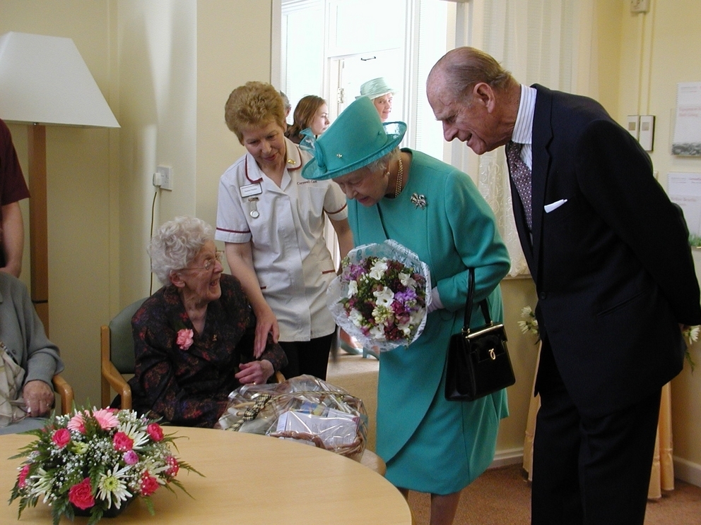 The Queen and Prince Philip are presented with a hamper of Cornish goodies by Mountford House resident Muriel Harris, aged 93