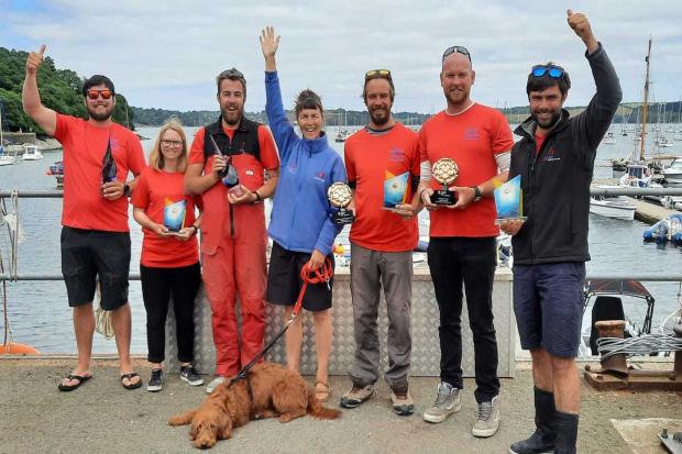 Tracey Boyne (centre) and the winning team from Mylor Sailing & Powerboat School at their Mylor Yacht Harbour HQ. Photo - Mylor Sailing School. Picture - Mylor Sailing School