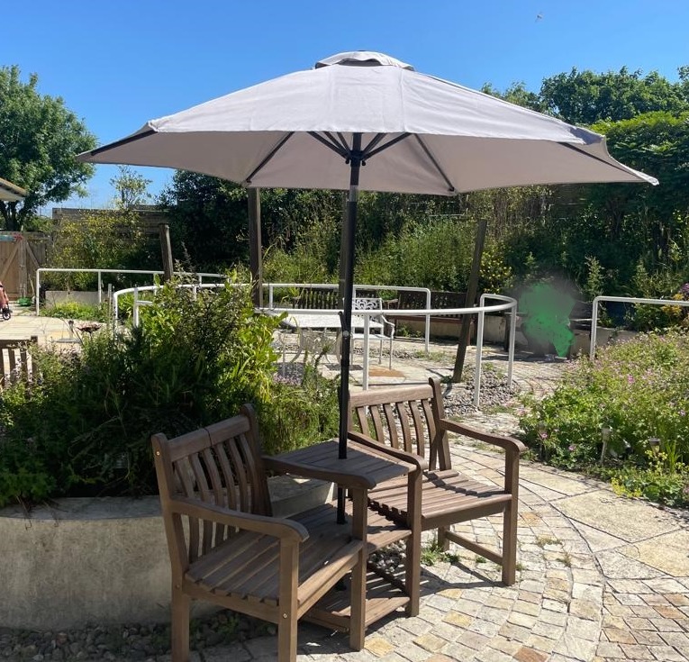 Patients can enjoy the outside seating with a parasol 