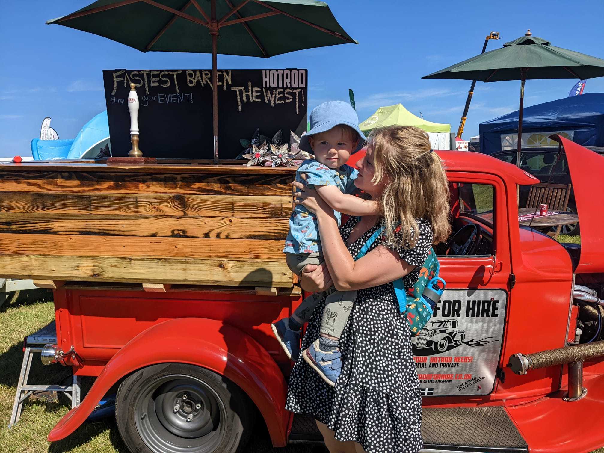 Little Alfie with his mum looking at this vintage hot rod
