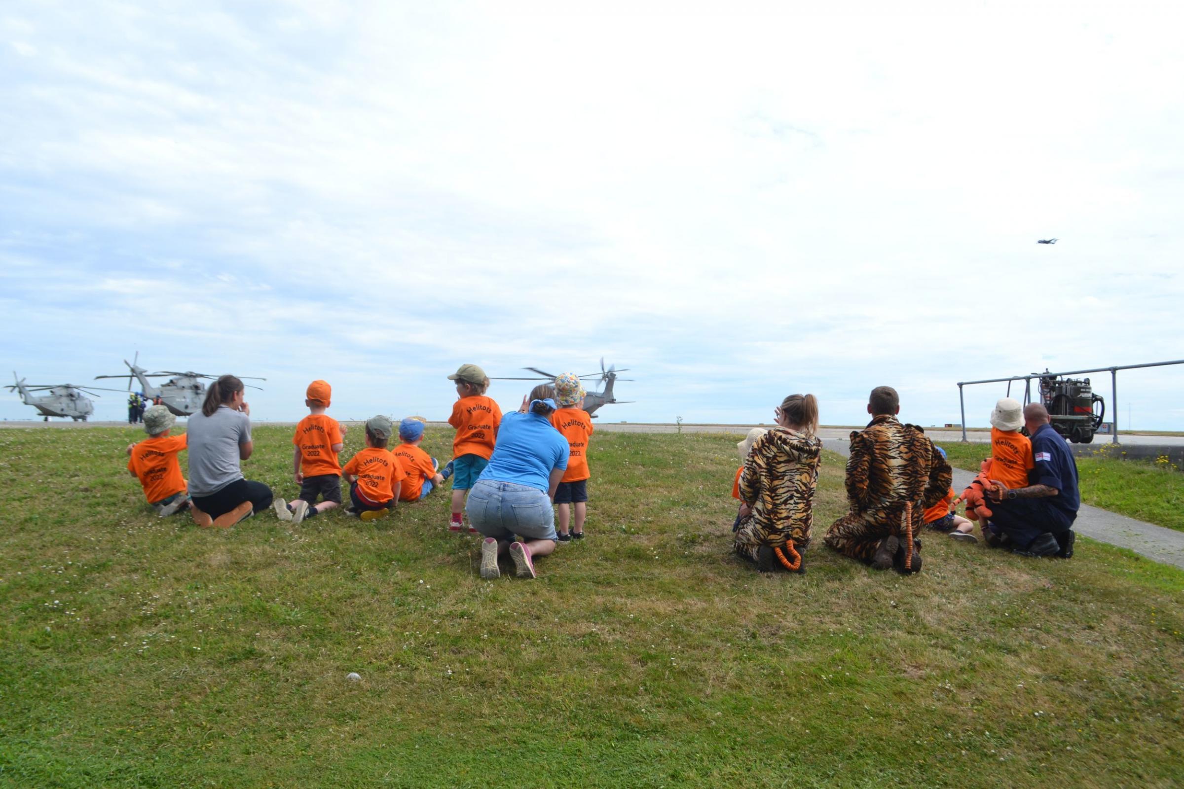 The children watched the helicopters on base
