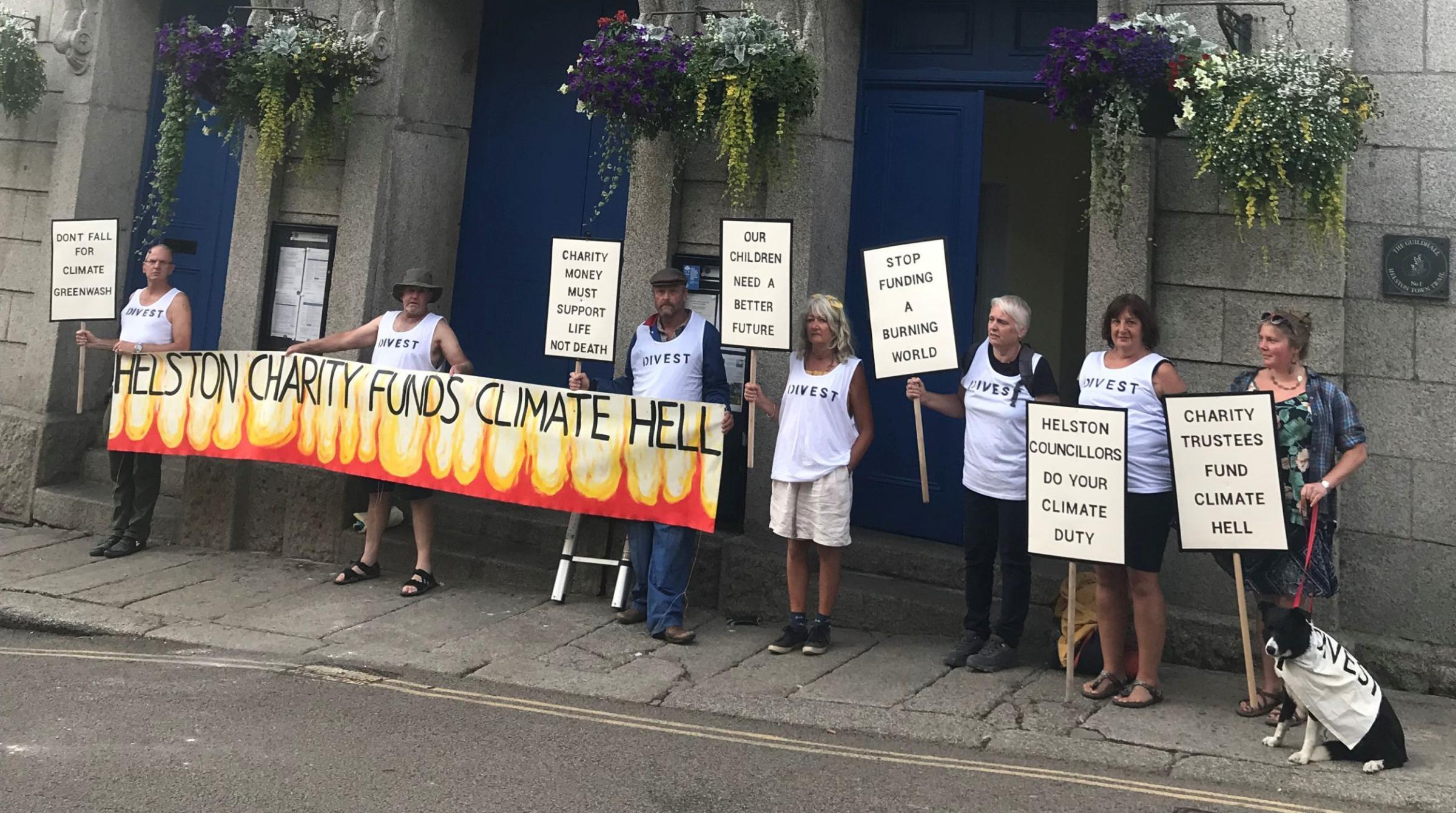 Protestors outside the Guildhall in Helston with banners