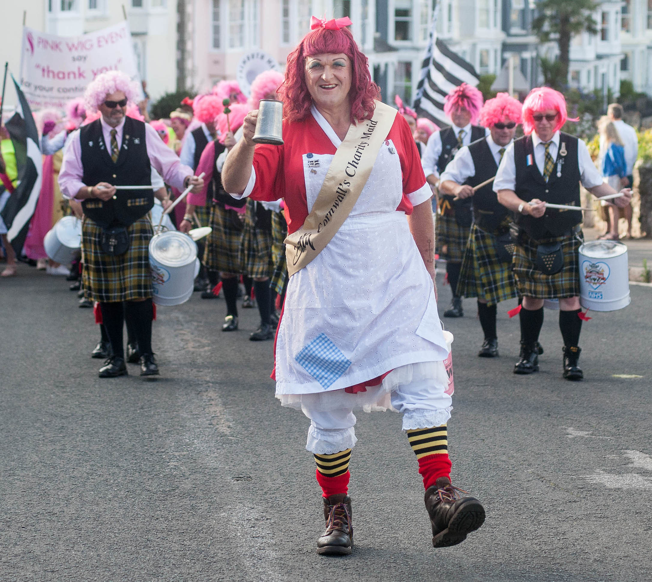 Falmouth Pink Wig Parade from the Greenbank Hotel to Church Street car park on Friday evening: The Falmouth Marine Band and Betty Stogs leads the parade. Picture by Colin Higgs