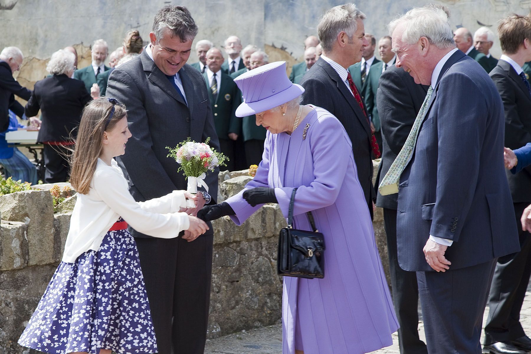 A bouquet for the Queen at St Michaels Mount from Emily Earley aged 9, with Lord St Levan.