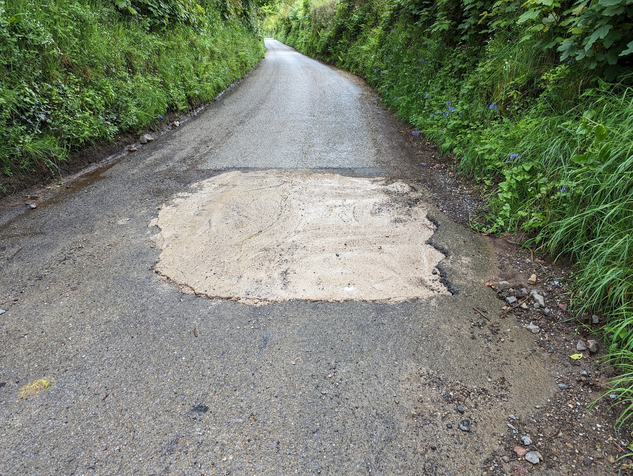 A mystery \volunteer\ filled the Lostwithiel pothole with concrete