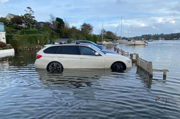 A major sewage overflow has been reported at Mill Quay, Mylor. File pic of car stranded on the quay at high tide