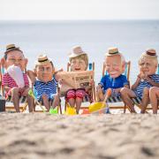 Oxfam campaigners pose as G7 leaders on Swanpool Beach near Falmouth. Picture: Aaron Chown/PA Wire