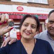 Postmaster Umesh Sanghani and wife Rashmita, of Dedworth Green Post Office in Windsor, with the new new Platinum Jubilee 50p coin. Picture: PA