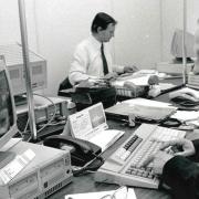 John Reynolds at work in the County Press newsroom in the early 1990s, with colleague George Chastney in the background.