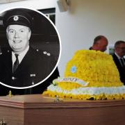 A bouquet in the shape of a firefighter's helmet was placed on Sidney's coffin
