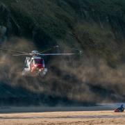 Helicopter coming into land on the beach by Stephen Crawford Davies