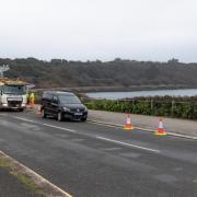 Workers painting yellow lines along Cliff Road, Falmouth