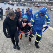 Nathan is brought ashore by the coastguard rescue team
