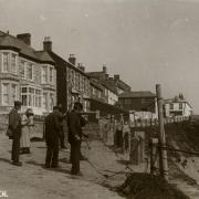 This lovely photo shows people mending nets at Cliff Road, Porthleven