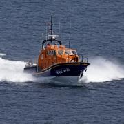 A fisherman clinging to his upturned boat was rescued by the Lizard Lifeboat