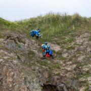 Coastguards scale a cliff to rescue dog Quince who had gone over the edge after not wearing a lead