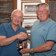 David Proud (left) being presented with his medal by Falmouth RNLI coxswain Jonathon Blakeston at Falmouth Lifeboat Station