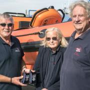 Mick and Margaret French being presented with their medals by Falmouth RNLI coxswain Jonathan Blakeston