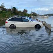 A major sewage overflow has been reported at Mill Quay, Mylor. File pic of car stranded on the quay at high tide