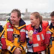 Helen with Penlee Lifeboat volunteers shortly after winning gold at the Olympics
