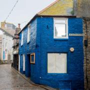 There is uproar over a building in one of St Ives' historic streets being painted dark blue