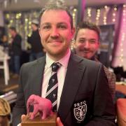 Captain Alex Bullock with the Pink Elephant Trophy