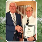 Bruce Taylor (left) is presented with his gold medal by Cornwall County FA director Steve Carpenter