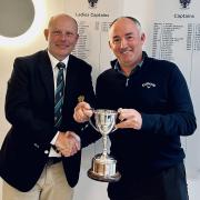 Falmouth Golf Club captain Phil Jones presents Paul Caunter with the John Rose Memorial Trophy