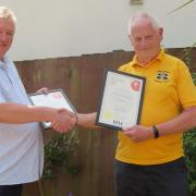 Hole in the Wall landlord Steve Hall (left) presented with the Pub of the Year 2024 award by Vince Curtis