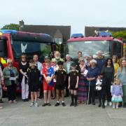 Local Community Group representatives get their cheques from Falmouth Fire Brigade