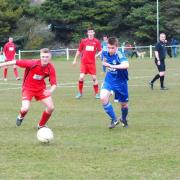 Josh Burton, wearing blue, during his time at Perranporth. He has rejoined Penryn Athletic