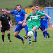 Helston's Jamie Thirkle looks to get the ball off Mousehole's Owain Barrett. Picture: PHIL RUBERRY
