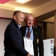 Alan Truscott receives his award from England coach Eddie Jones