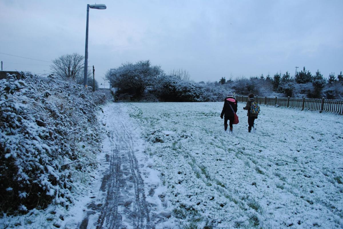 A snowy walk to school across the fields in Helston on Monday