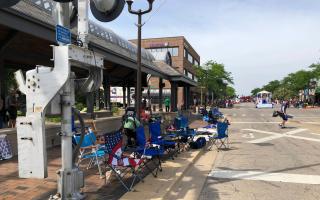 Empty chairs on the pavement after spectators fled (Lynn Sweet/Chicago Sun-Times/AP)