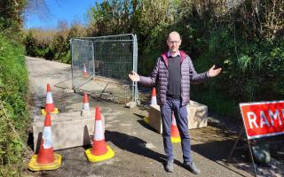 A frustrated Cllr Colin Martin at the scene of the Lostwithiel pothole, which has closed the road