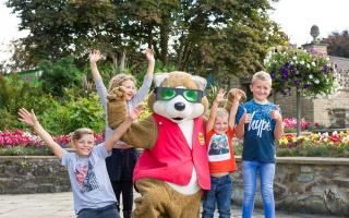 Children celebrating with Flambards mascot, Ferdi the Fox